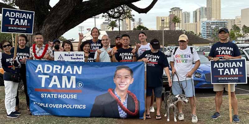 Scott Goold and Crew sign waving for victorious Adrian Tam