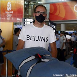 U.S. cycling team member wearing black pollution mask