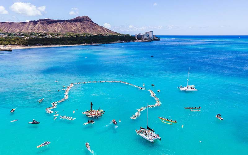 Paddle out under iconic Leahi (Diamond Head)